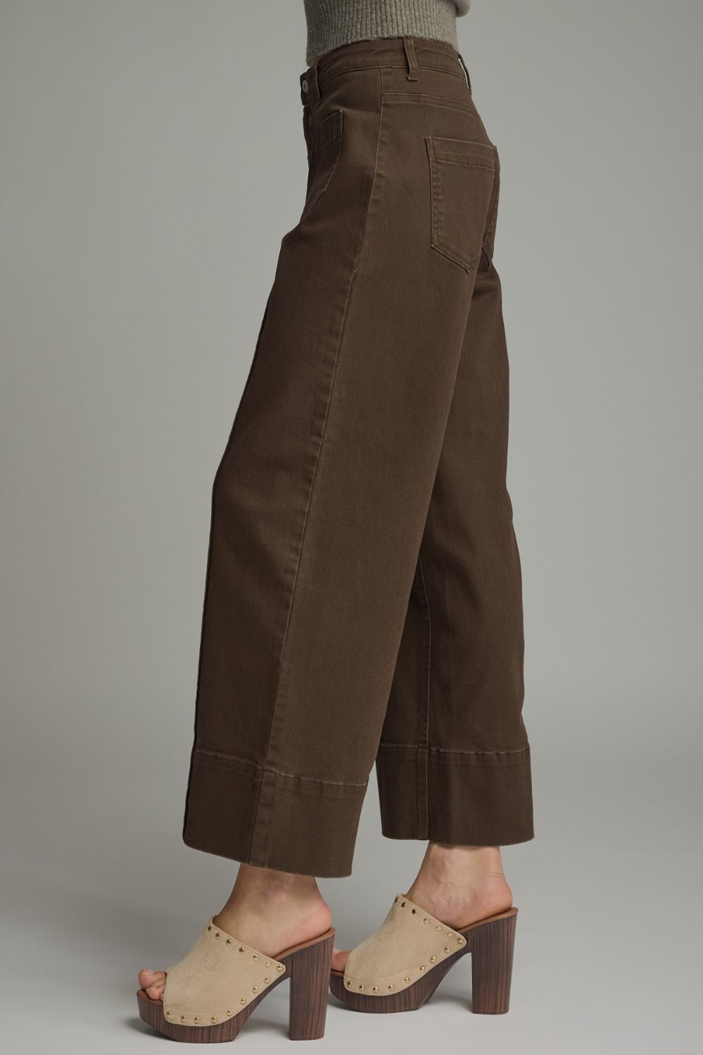 Brown wide-leg pants worn by a person on a plain background