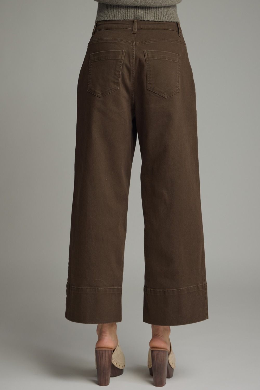 Brown wide-leg pants on a neutral background