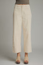 Beige pants worn by a person on a gray background