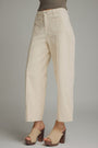Beige pants worn by a person on a gray background