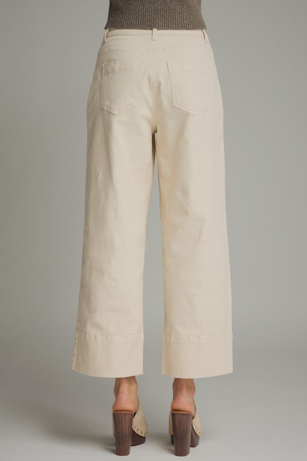 Beige wide-leg pants on a neutral background