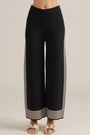 Black wide-leg pants with cream vertical side stripes and striped hem detailing.