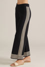 Black wide-leg pants with cream side stripe panel and striped hem cuff.