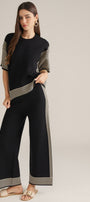 Black wide-leg pant set with cream striped hem and side stripe, elastic waist.