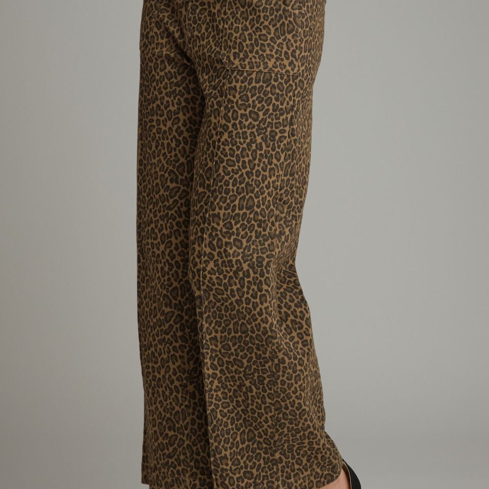 A person wearing leopard-print wide-leg cropped pants with black heeled sandals, shown from the waist down against a plain light gray studio background.