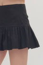 Black skirt worn by a person on a white background