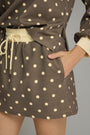 Brown polka dot skirt with a plain background