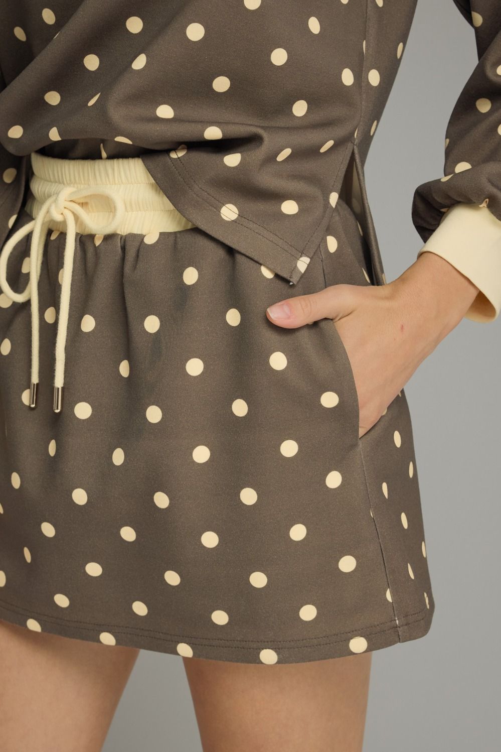 Brown polka dot skirt with a plain background