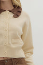 women wearing a long sleeve cropped sweater with a brown ruffle collar detail