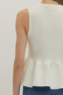 White sleeveless top worn by a person on a plain background