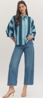 Woman wearing a striped shirt and jeans on a white background