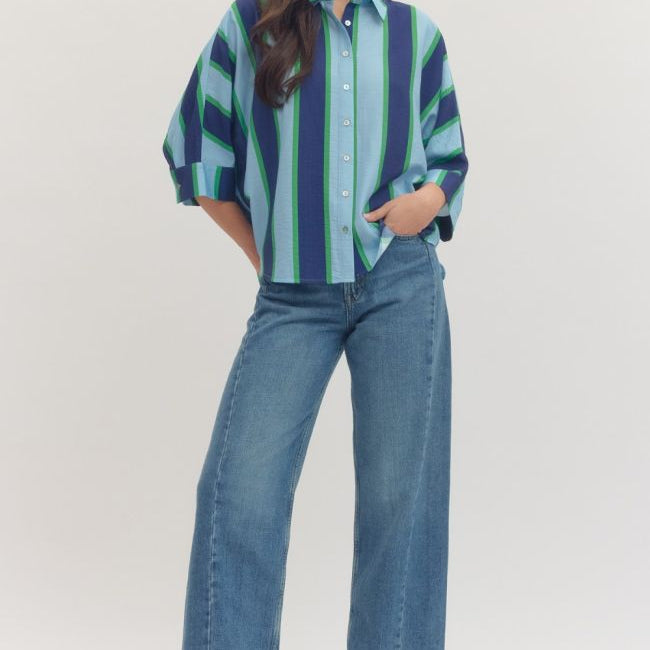Woman wearing a striped shirt and jeans on a white background