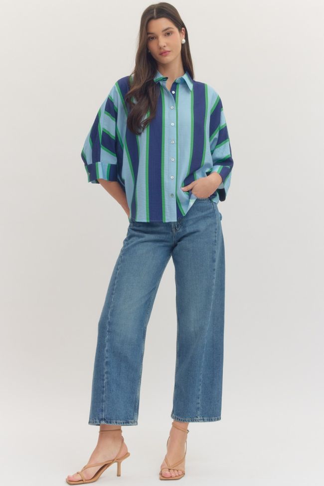 Woman wearing a striped shirt and jeans on a white background