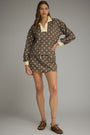 Woman wearing a polka dot outfit with a brown background