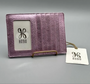 Pink leather cardholder with 'Hobo' branding on a gray background