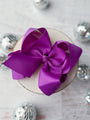 Large purple bow on a light gray background
