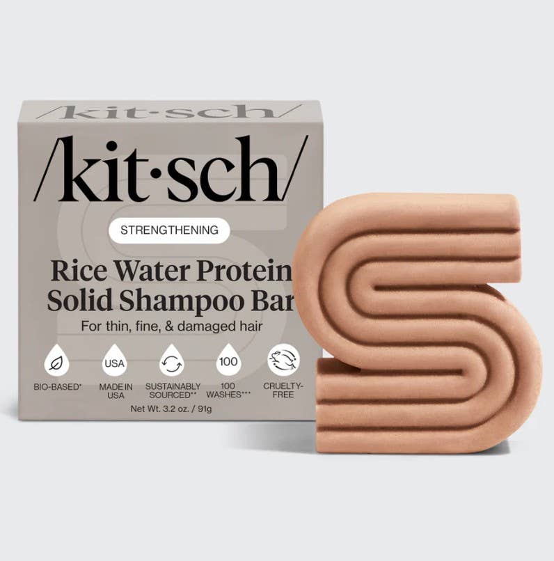 Kitsch rice water protein solid shampoo bar packaging with a beige shampoo bar on a light gray background
