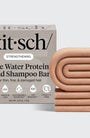 Kitsch rice water protein solid shampoo bar packaging with a beige shampoo bar on a light gray background