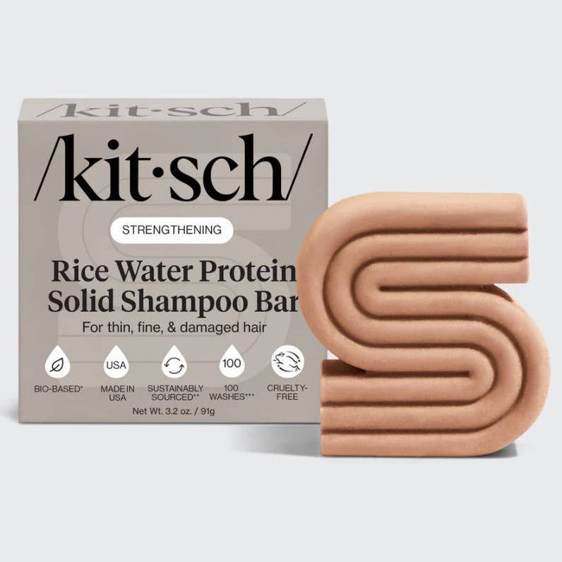 Kitsch rice water protein solid shampoo bar packaging with a beige shampoo bar on a light gray background