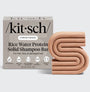Kitsch rice water protein solid shampoo bar packaging with a beige shampoo bar on a light gray background