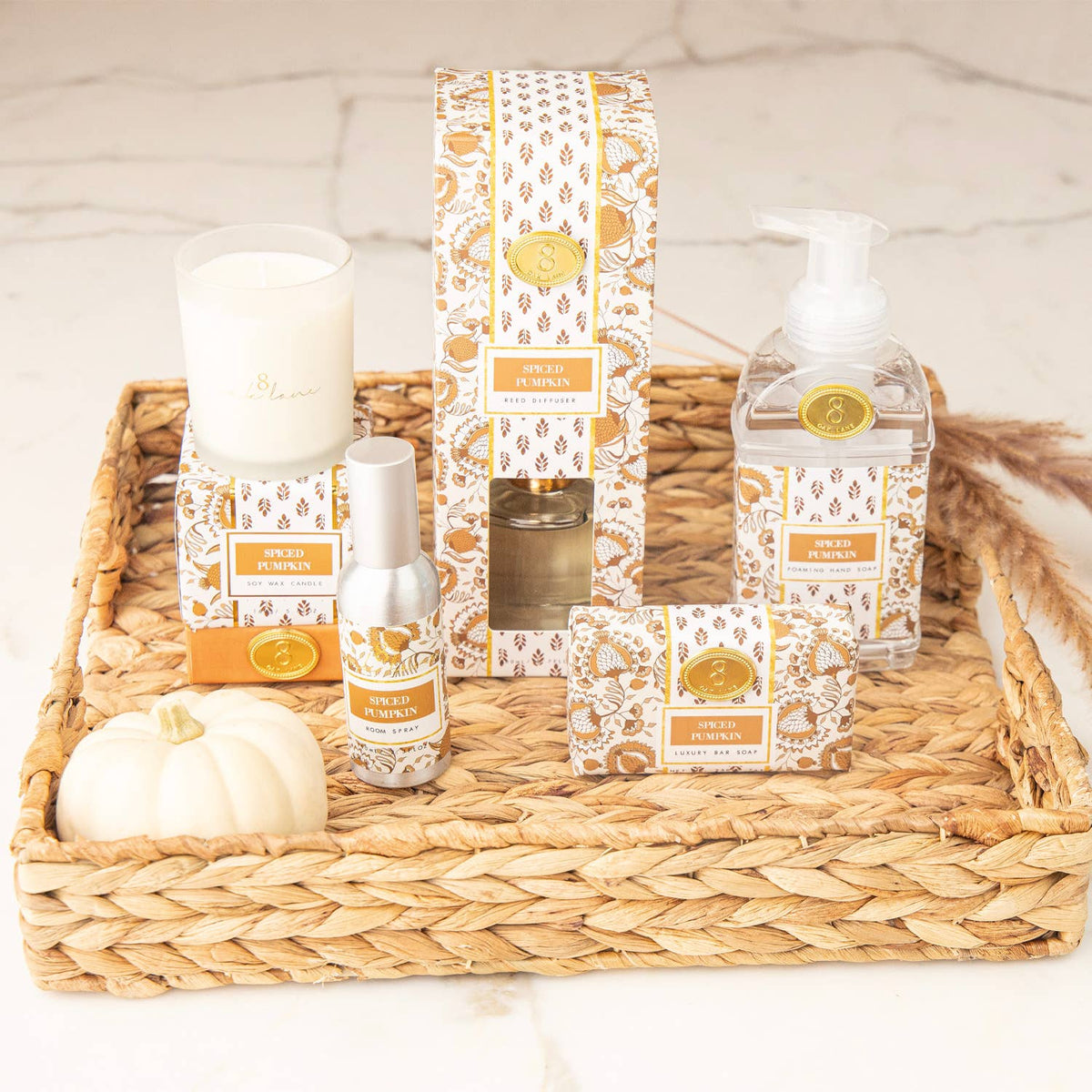 Foaming hand soap pump bottle with spiced pumpkin label, displayed with matching items