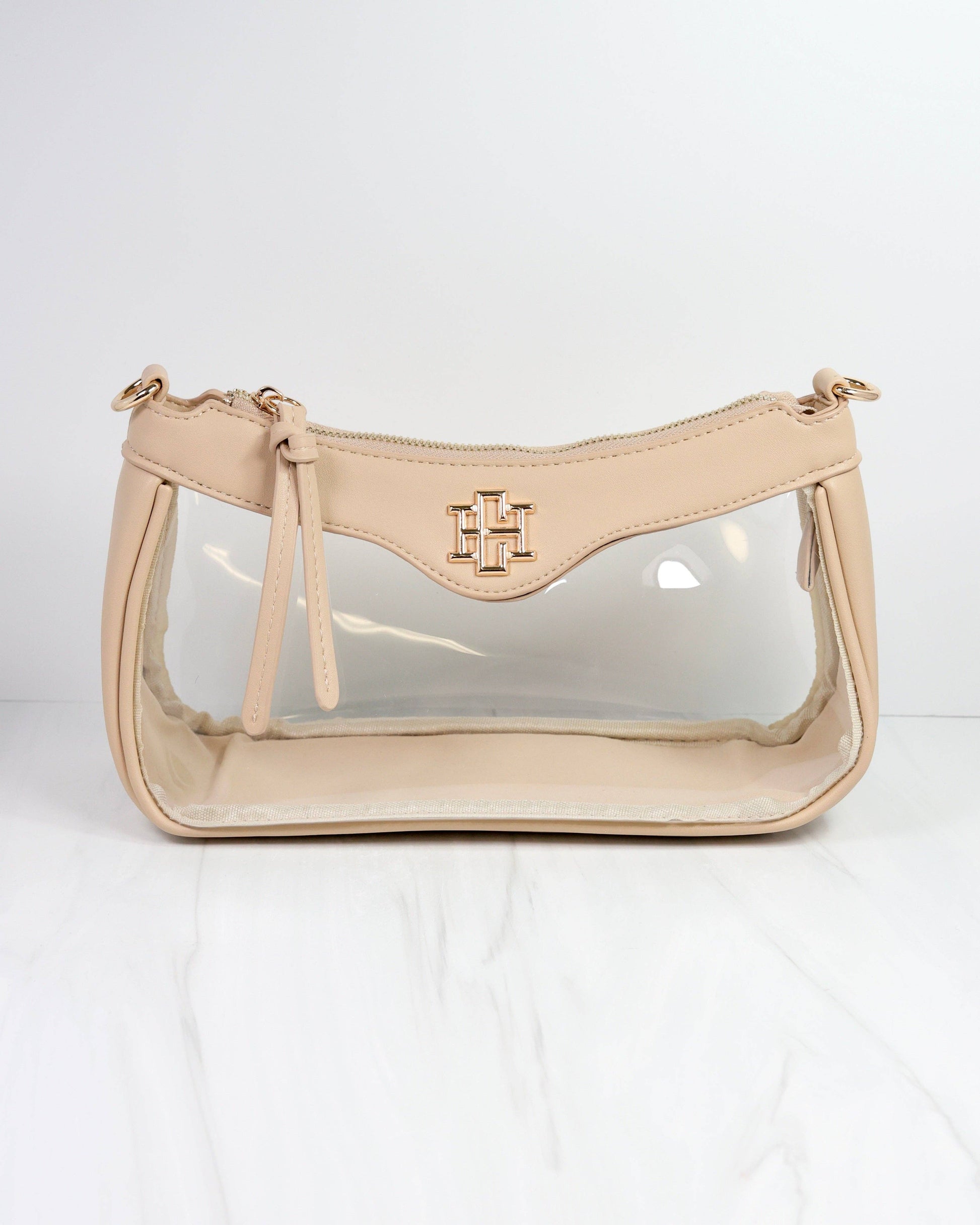 Beige handbag with clear front section on a white background