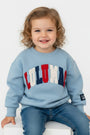 Child wearing a light blue sweatshirt with colorful letters on a white background