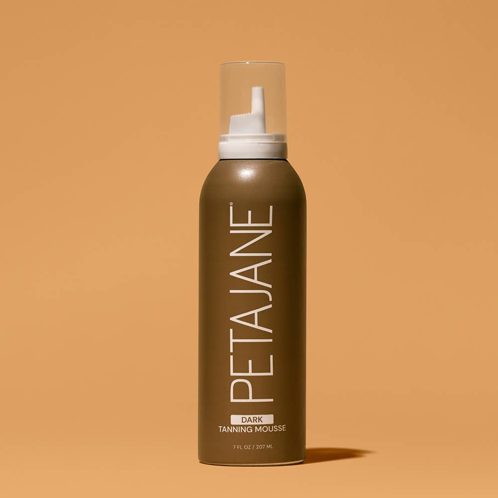 Brown bottle of PETAJANE tanning mousse on a beige background