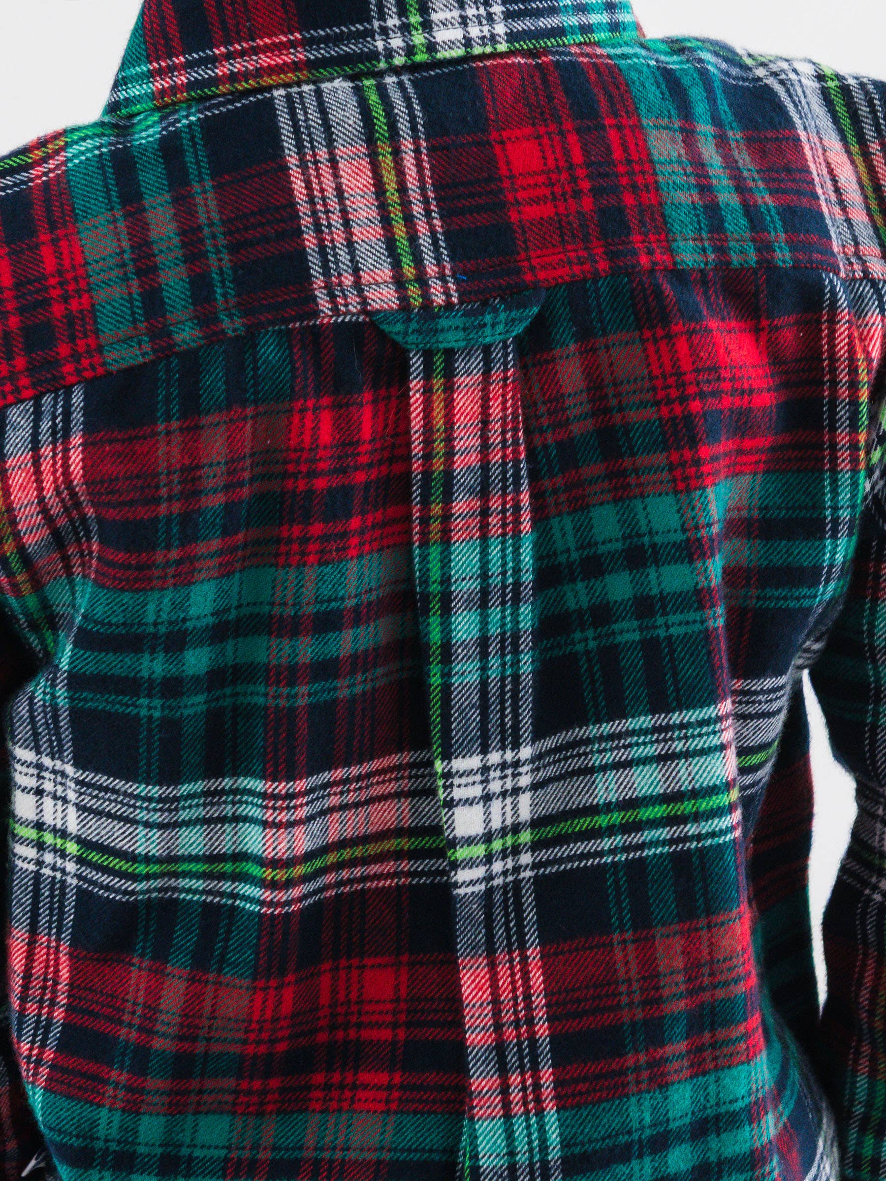 Close-up of a plaid fabric with red, green, and black colors.