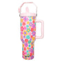 Colorful floral-patterned tumbler with pink handle and lid on a white background