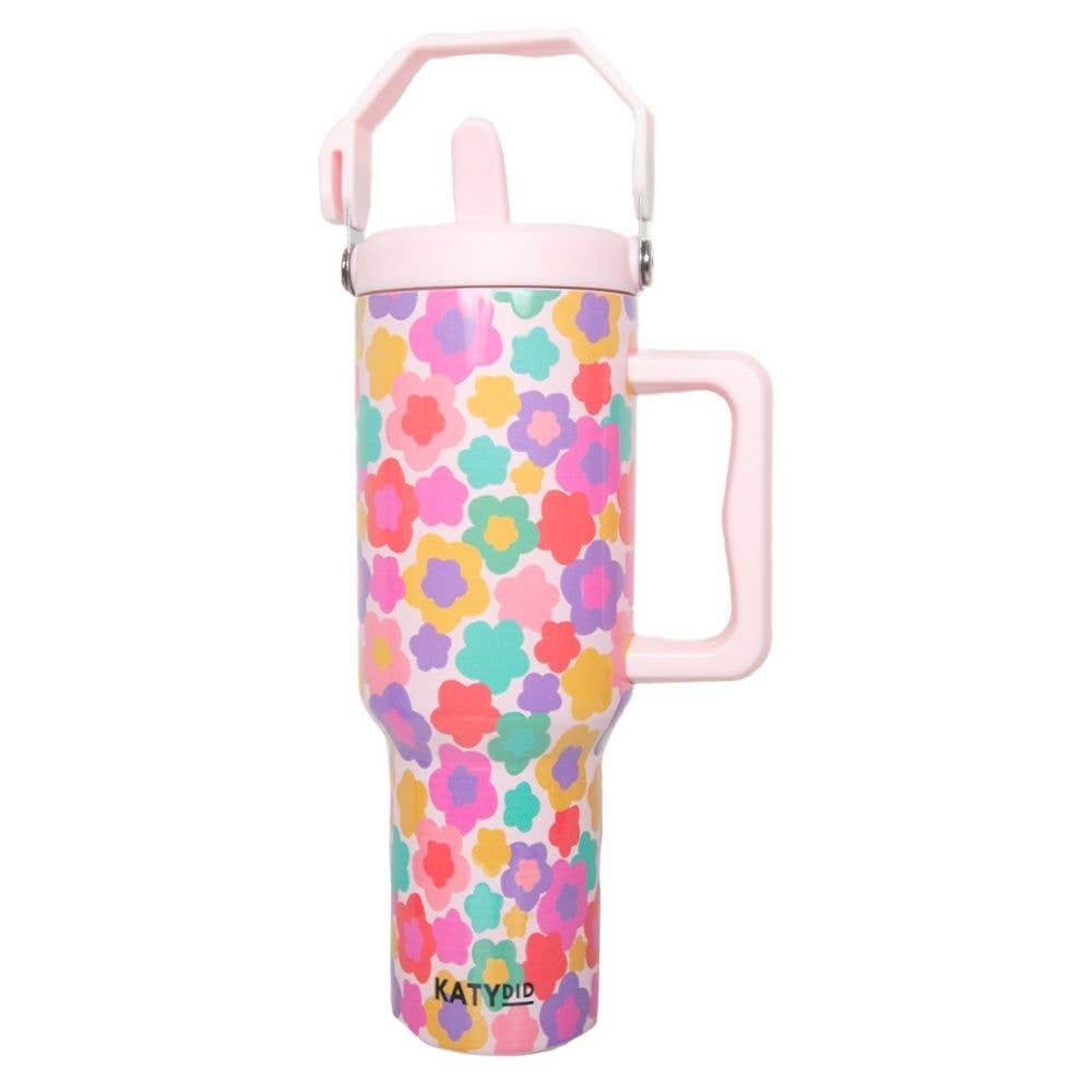 Colorful floral-patterned tumbler with pink handle and lid on a white background