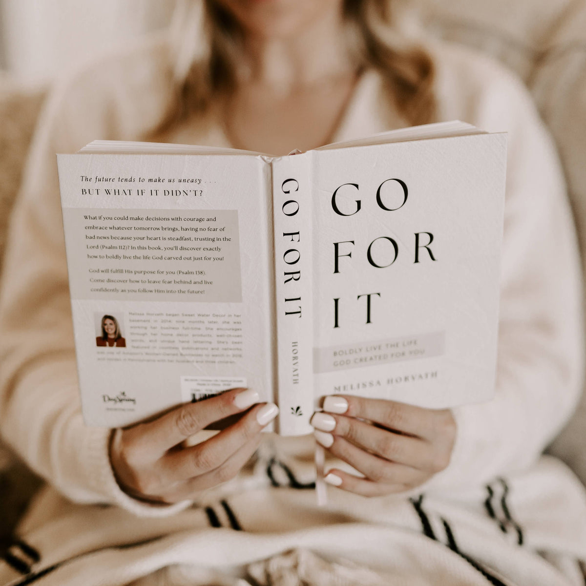 Open book pages showing 'Go For It' title and devotional text with hands
