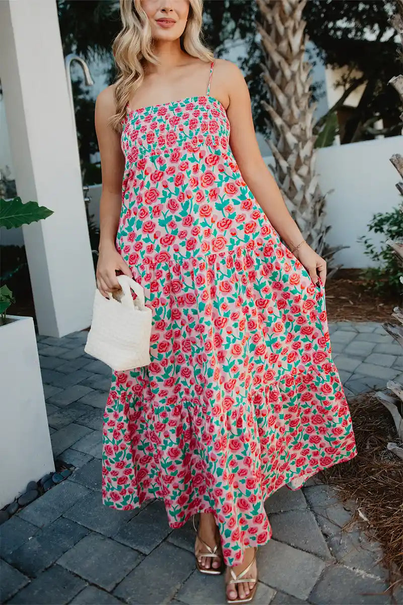 Woman wearing a floral dress walking outdoors.
