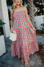 Woman wearing a floral dress walking outdoors.