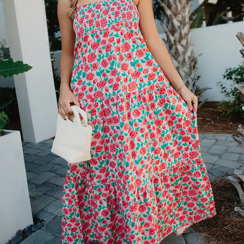 Woman wearing a floral dress walking outdoors.