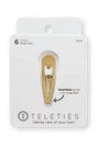 Gold hair clip on a Teleties packaging with text about seamless tip feel.