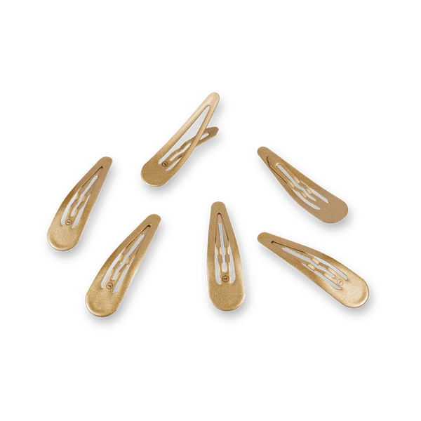Set of gold hair clips on a white background