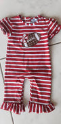 Red and white striped baby romper with a teddy bear design on a tiled floor.