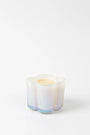 Candle in a decorative glass container on a white background