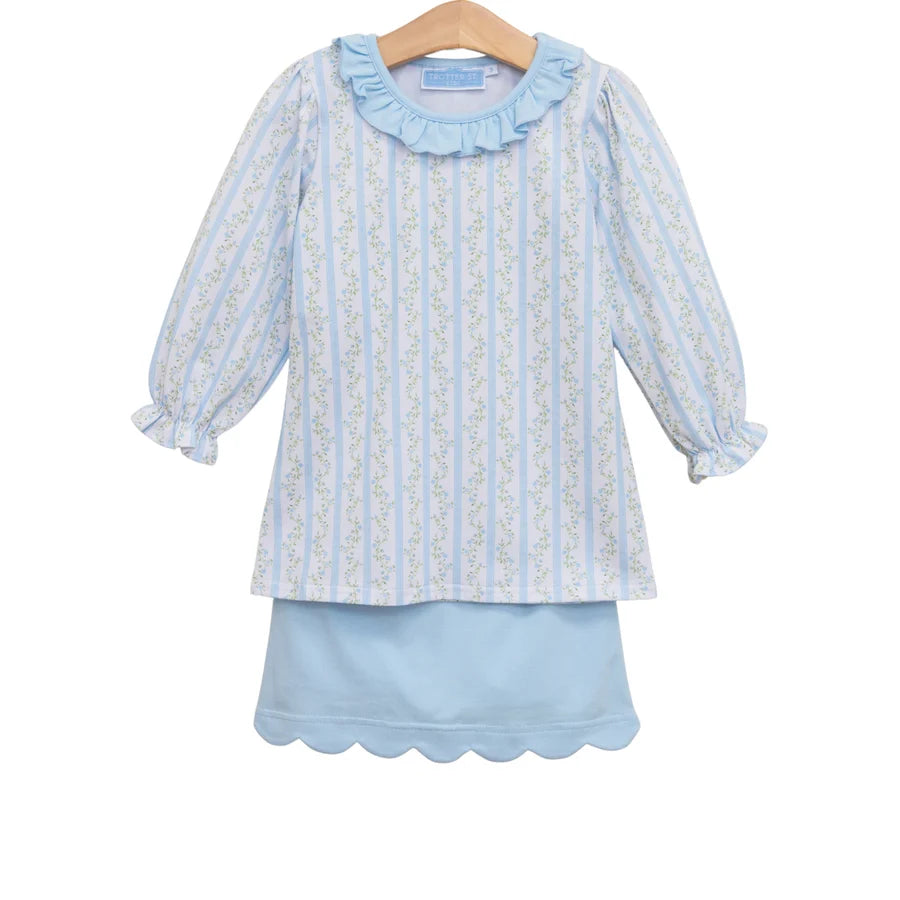 A light blue and white vertically striped long-sleeve blouse with a ruffled collar and scalloped edges, shown on a wooden hanger against a plain white background.