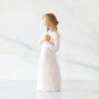 Statue of a woman in a white dress with a plain background