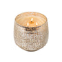 Candle in a textured metallic holder on a white background