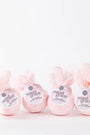 Four pink bath bombs labeled 'sweet grace' on a white background