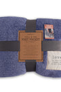 Folded blue foot pocket blanket with a label on a white background