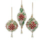 Three Christmas tree ornaments hanging against a white background: one teardrop-shaped ornament in the center and two round ornaments on either side. The ornaments are cream-colored with red and green floral patterns and small bead accents.