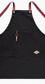 Black apron with red straps on a white background