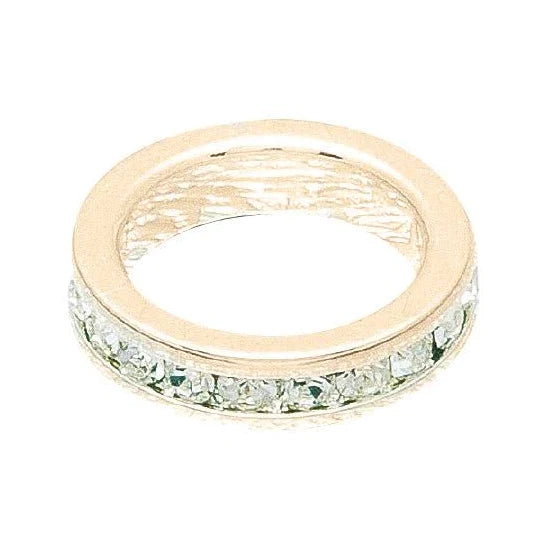 Gold ring with green gemstones on a white background