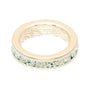 Gold ring with green gemstones on a white background