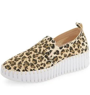 Leopard print slip-on sneaker with a white sole on a white background