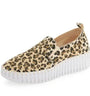 Leopard print slip-on sneaker with a white sole on a white background